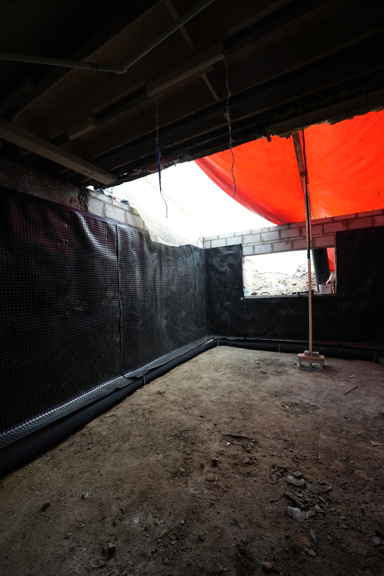 Addition foundation with waterproofing membrane